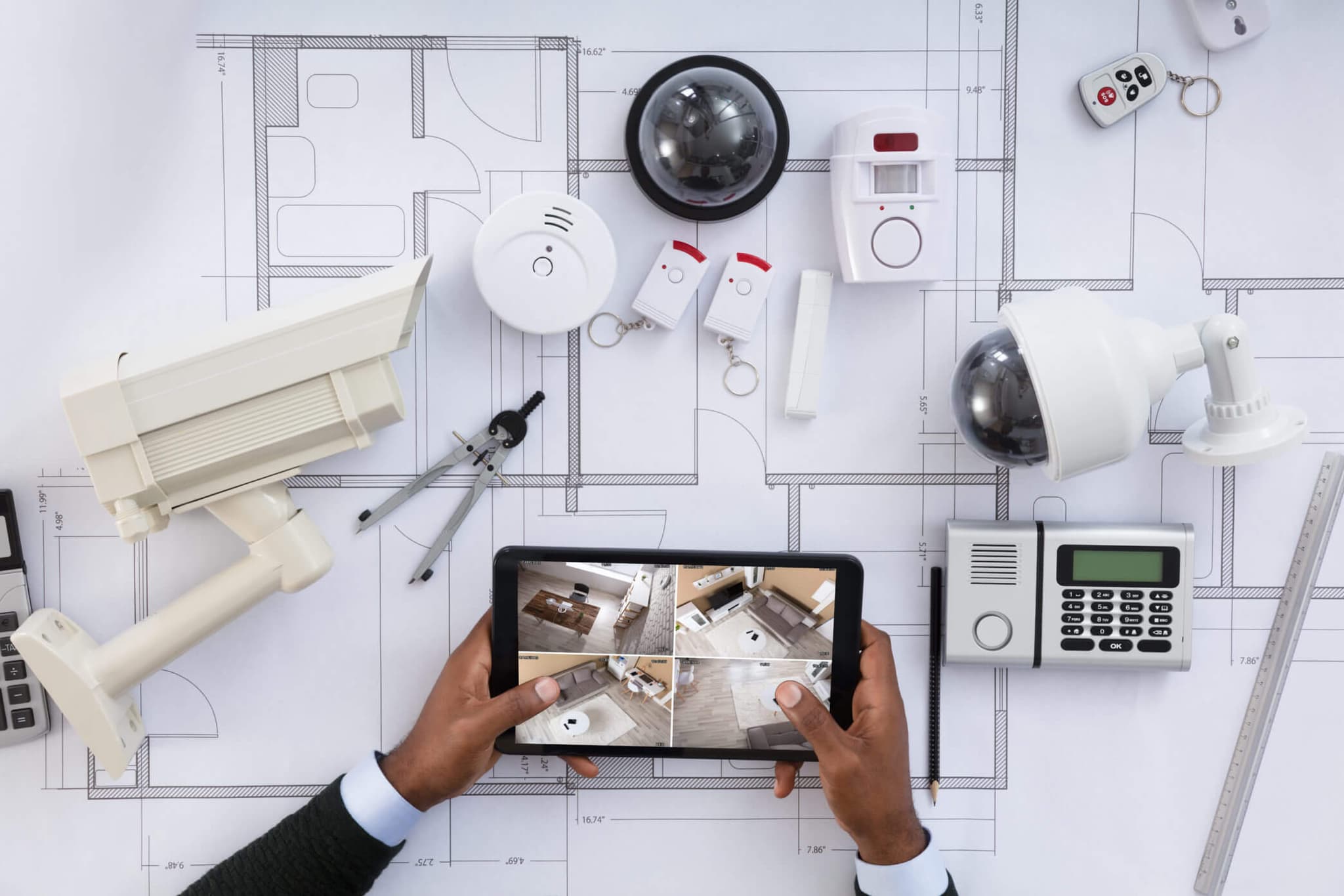 Smart security and automation devices planned over a building blueprint